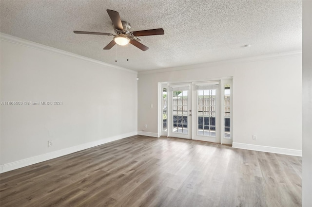 unfurnished living room featuring ceiling fan, a textured ceiling, wood-type flooring, ornamental molding, and french doors