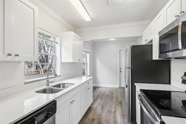 kitchen with sink, white cabinetry, and stainless steel appliances