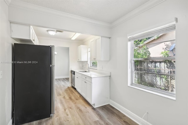 kitchen with sink, stainless steel appliances, white cabinets, crown molding, and light hardwood / wood-style flooring