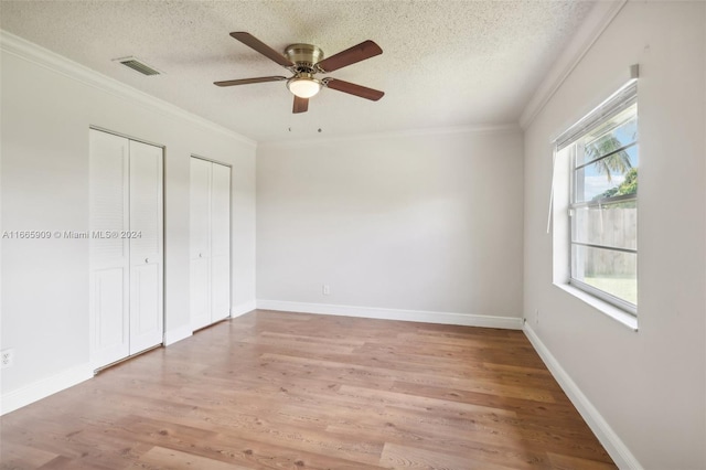 unfurnished bedroom with ceiling fan, wood-type flooring, and a textured ceiling