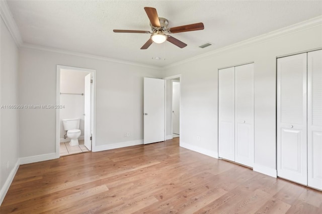 unfurnished bedroom featuring connected bathroom, ceiling fan, crown molding, and light wood-type flooring