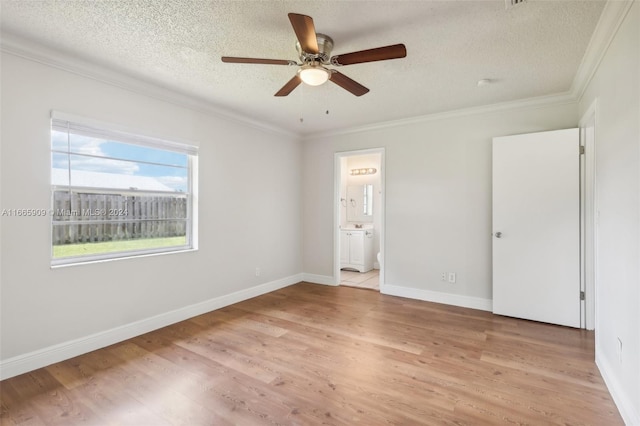 unfurnished bedroom featuring light hardwood / wood-style flooring, a textured ceiling, ensuite bathroom, and ceiling fan