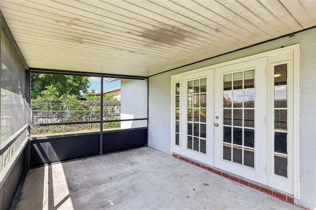 unfurnished sunroom featuring french doors and wood ceiling