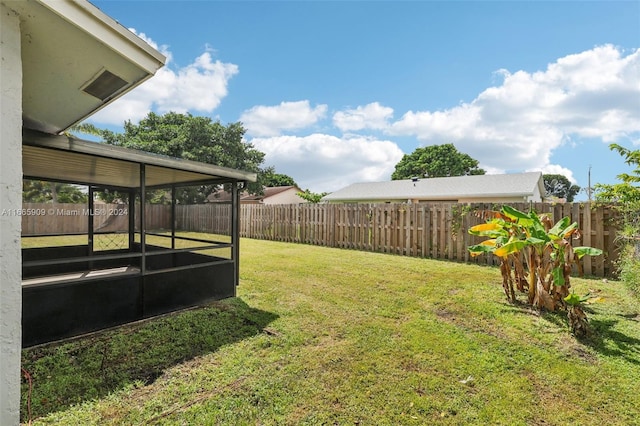 view of yard with a sunroom