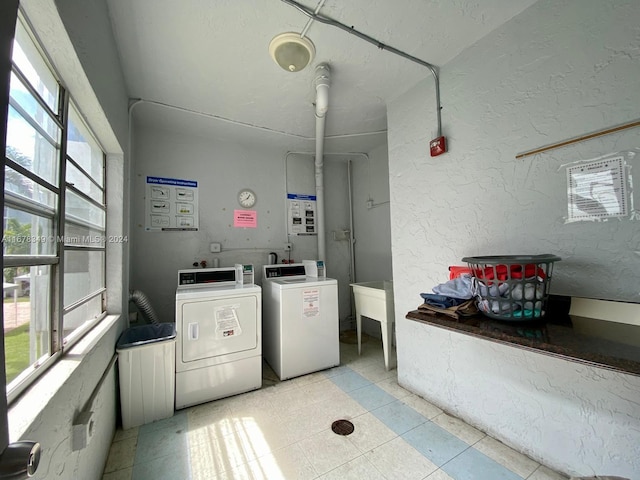 laundry area featuring washer and dryer and light tile patterned flooring