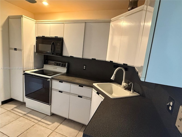 kitchen featuring white cabinets, sink, white electric range oven, and light tile patterned floors