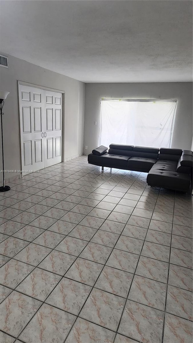 unfurnished living room with light tile patterned floors