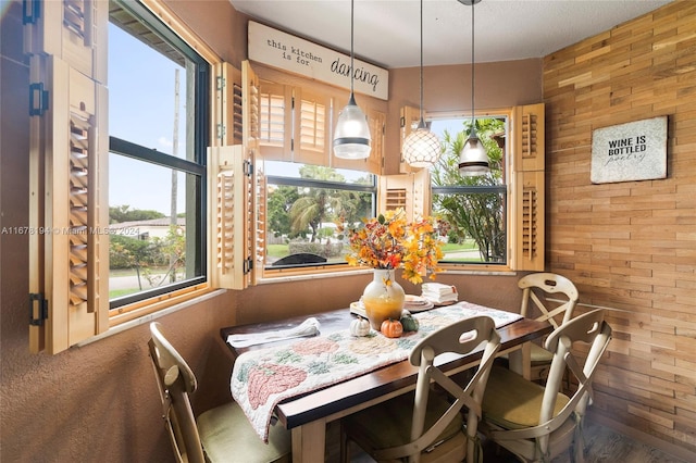 dining area featuring wood walls