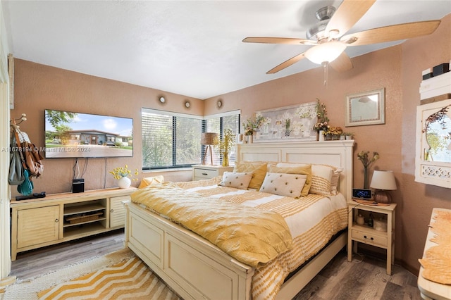 bedroom with hardwood / wood-style flooring and ceiling fan