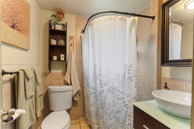 bathroom featuring vanity, tile walls, toilet, and walk in shower