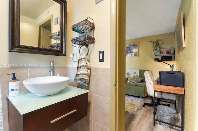 bathroom featuring vanity, tile walls, and hardwood / wood-style floors