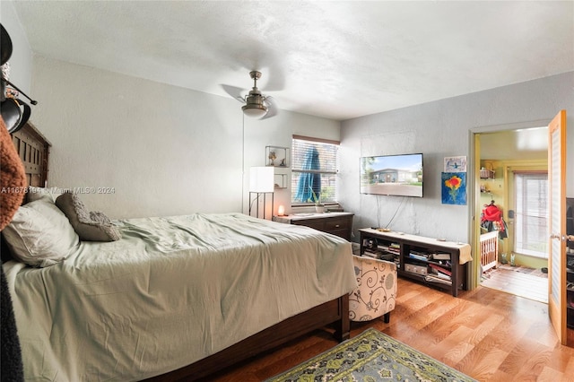 bedroom with light wood-type flooring and ceiling fan