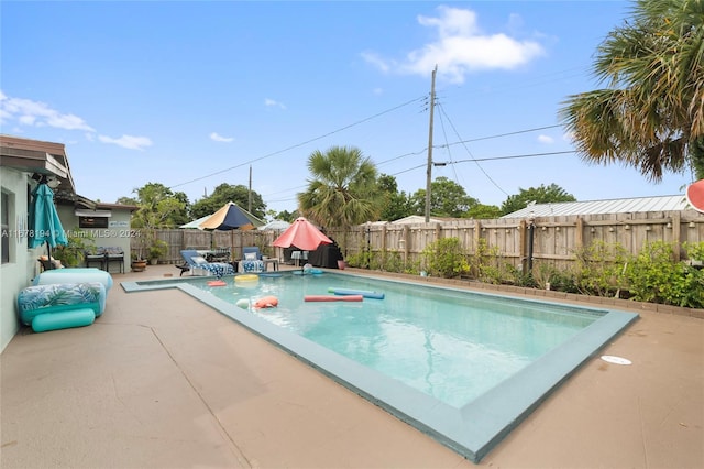 view of swimming pool with a patio area