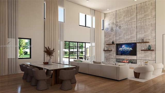 living room featuring a towering ceiling and light hardwood / wood-style floors