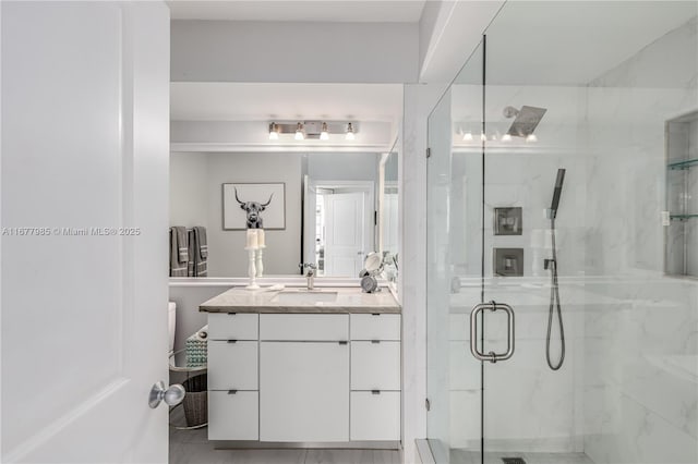 bathroom featuring an enclosed shower and vanity