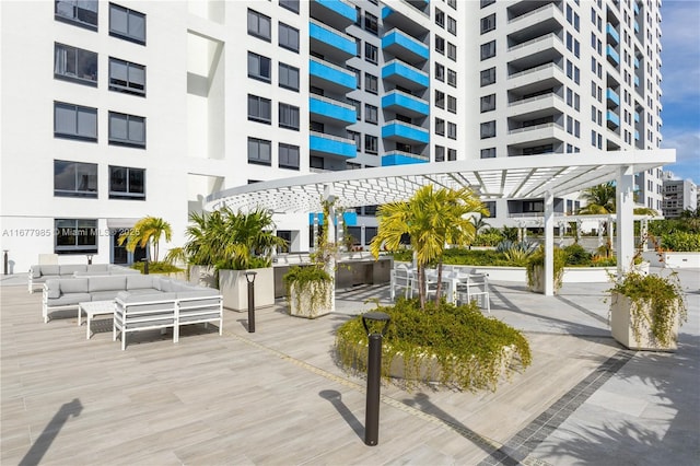 view of home's community with outdoor lounge area and a pergola