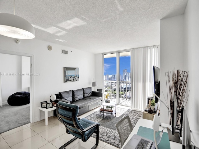 tiled living room featuring a textured ceiling