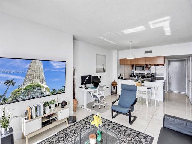 tiled living room with a textured ceiling