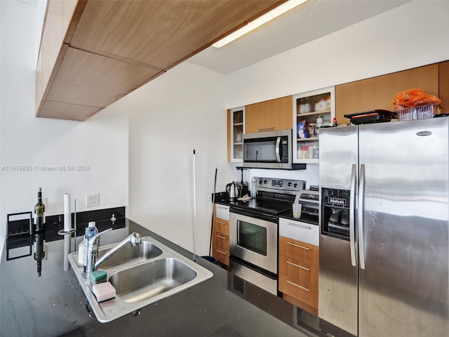 kitchen featuring concrete floors, stainless steel appliances, and sink