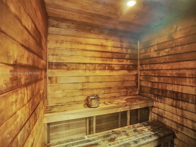 view of sauna / steam room featuring wood ceiling and wood walls