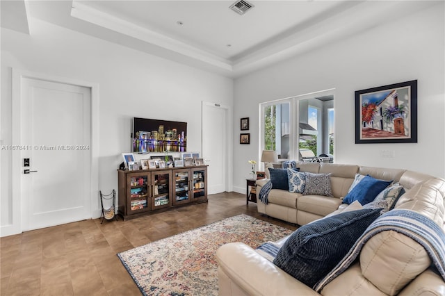 living room with a tray ceiling