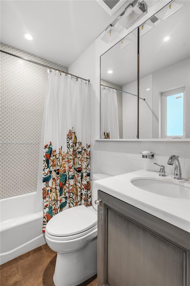 full bathroom featuring vanity, shower / tub combo with curtain, toilet, and tile patterned floors