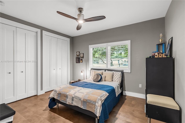 bedroom with two closets and ceiling fan