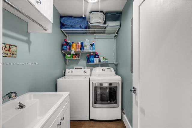 washroom with cabinets, independent washer and dryer, and sink