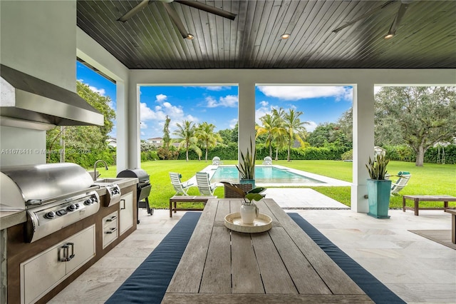 view of patio featuring exterior kitchen, ceiling fan, and grilling area