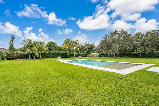 view of pool with a yard