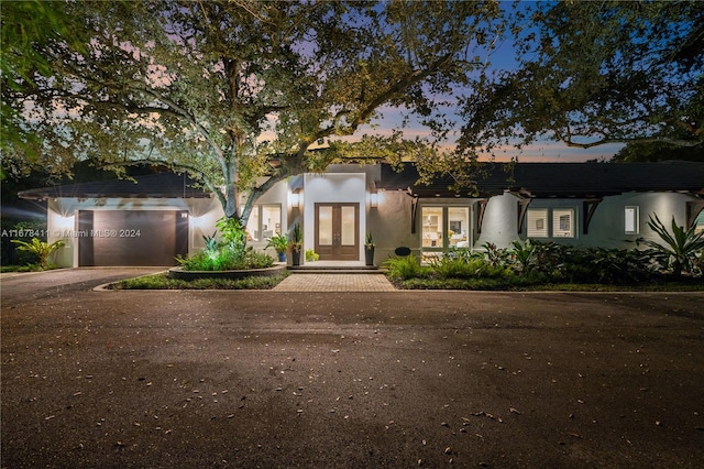 view of front facade featuring french doors and a garage