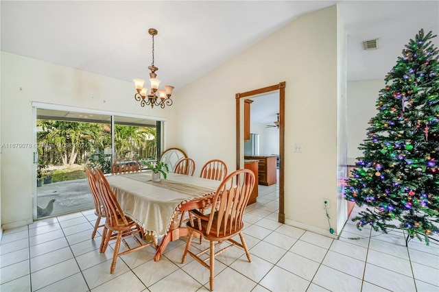 tiled dining space featuring ceiling fan with notable chandelier and lofted ceiling