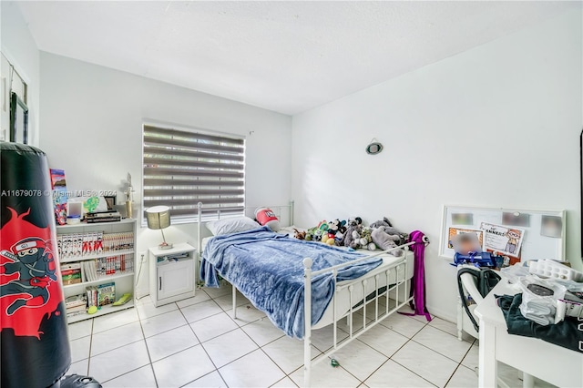 bedroom with light tile patterned floors