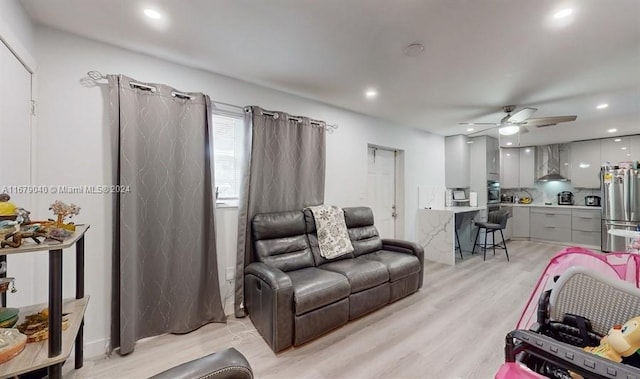 living room featuring light wood-type flooring and ceiling fan