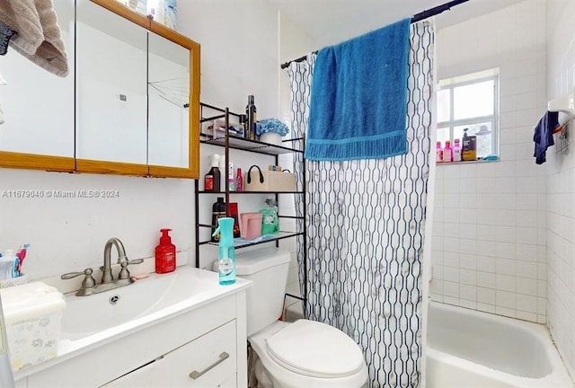 full bathroom featuring vanity, shower / bath combo with shower curtain, and toilet