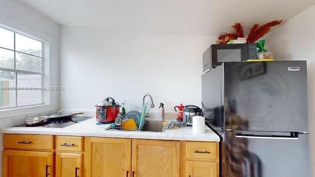 kitchen featuring sink and stainless steel fridge