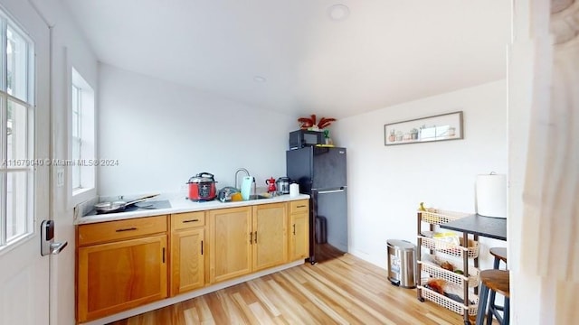 kitchen with black appliances and light wood-type flooring