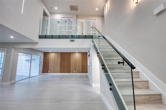 115 Ocean Dunes Cir, Jupiter, FL 33477 - staircase with wood finished floors, baseboards, a high ceiling, and recessed lighting