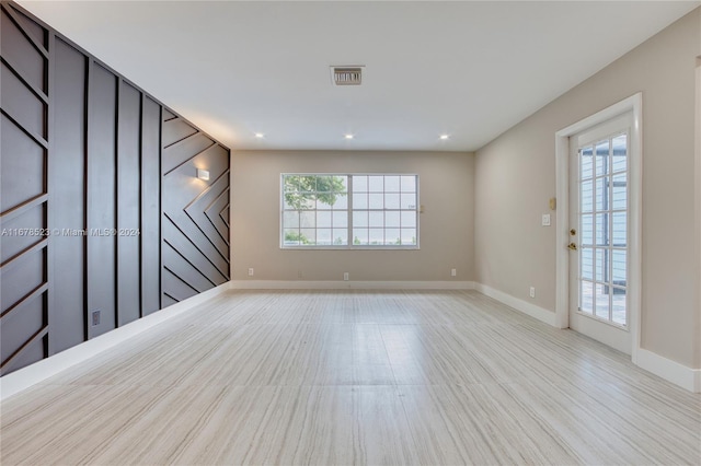 empty room with light wood-type flooring and plenty of natural light