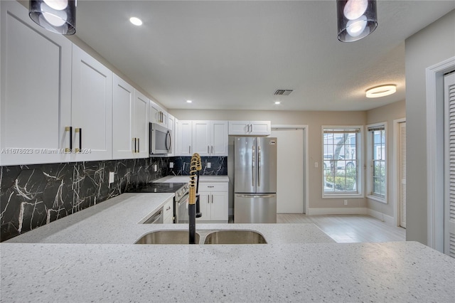 115 Ocean Dunes Cir, Jupiter, FL 33477 - kitchen featuring stainless steel appliances, light stone countertops, tasteful backsplash, white cabinetry, and recessed lighting