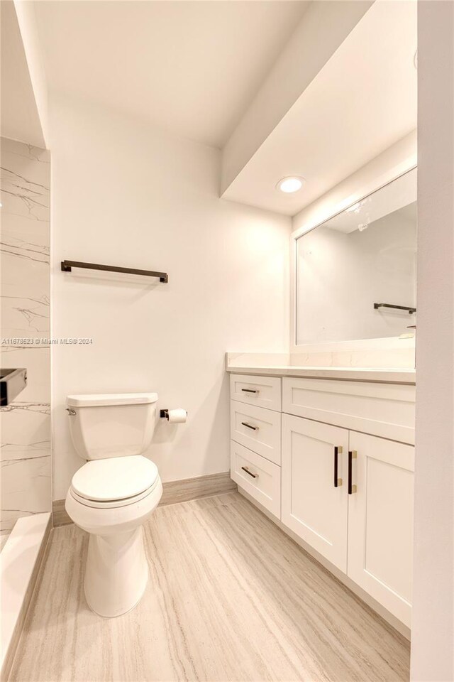 115 Ocean Dunes Cir, Jupiter, FL 33477 - bathroom featuring vanity, toilet, baseboards, and a shower