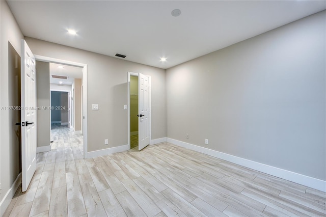 empty room with light hardwood / wood-style flooring