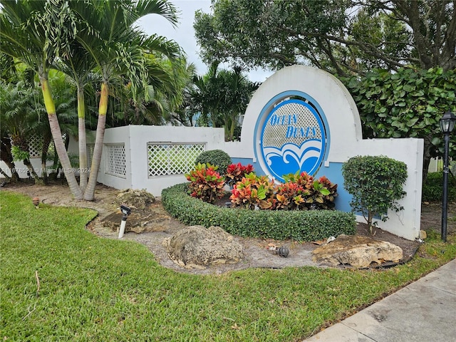 community / neighborhood sign featuring a lawn