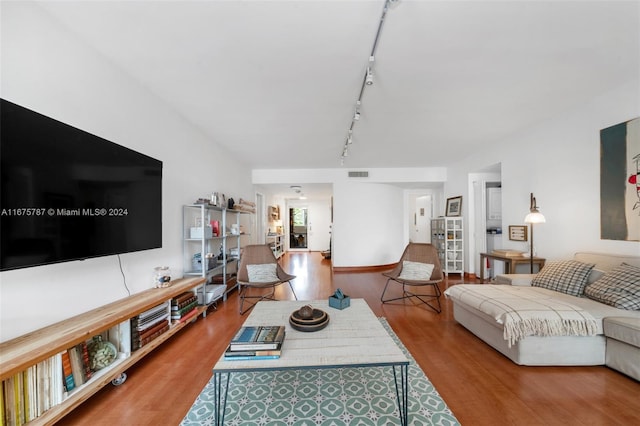 living room featuring hardwood / wood-style flooring and track lighting