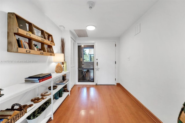 hall with hardwood / wood-style floors