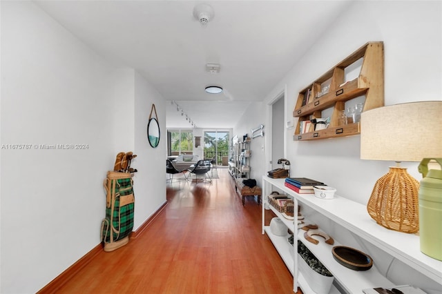 hall with hardwood / wood-style floors