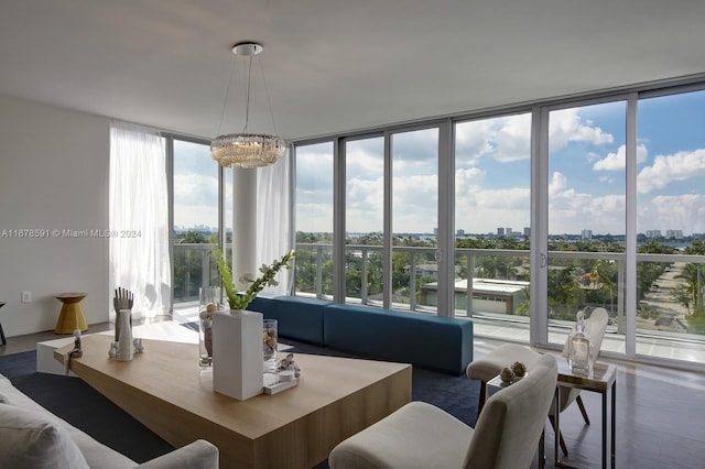 living room featuring expansive windows, a chandelier, and plenty of natural light