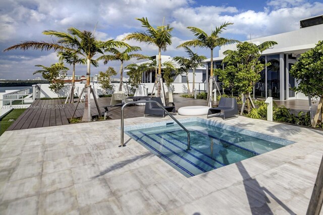 9940 W Bay Harbor Dr Unit 7G-N, Bay Harbor Islands, FL 33154 - view of swimming pool with a community hot tub, a patio area, and a deck