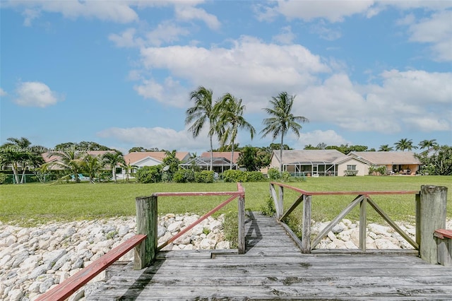 view of dock featuring a yard and a deck