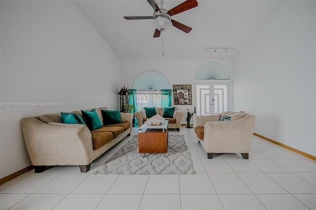 tiled living room featuring lofted ceiling, rail lighting, and ceiling fan